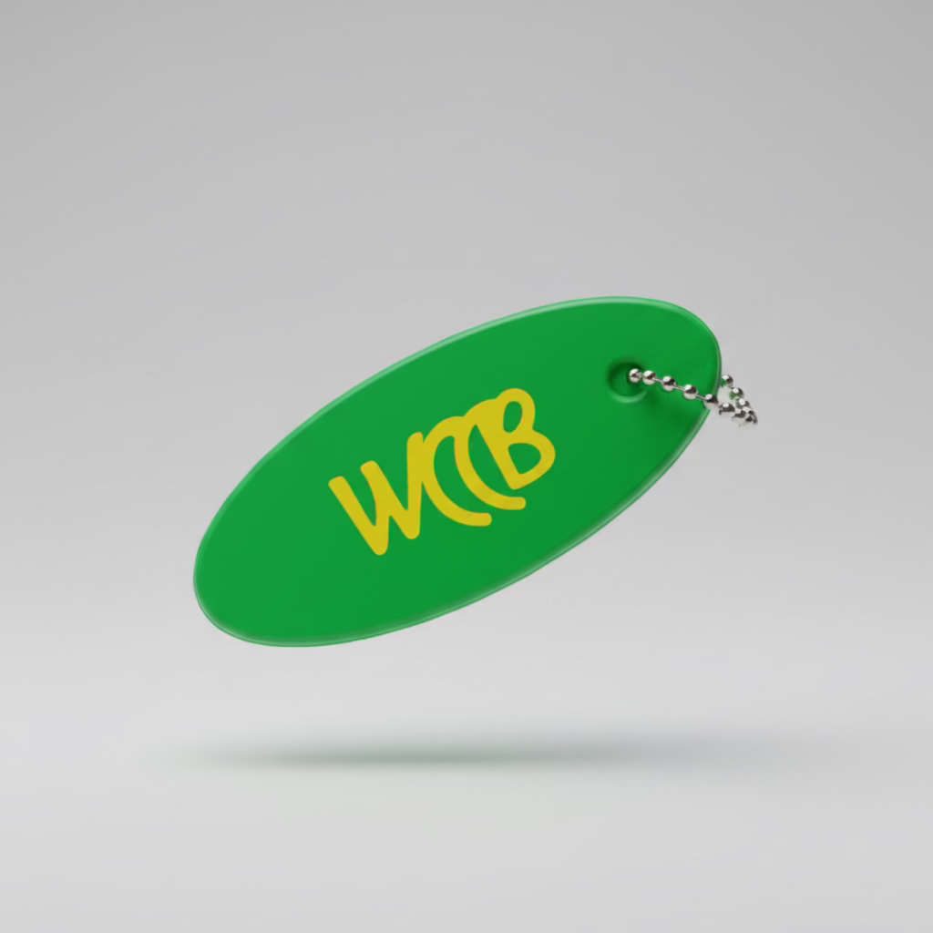 Green floating keychain with yellow WCCB logo on a studio background