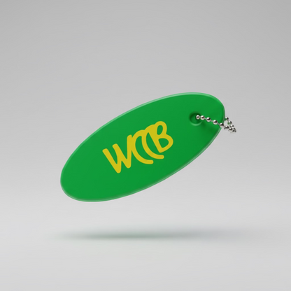 Green floating keychain with yellow WCCB logo on a studio background