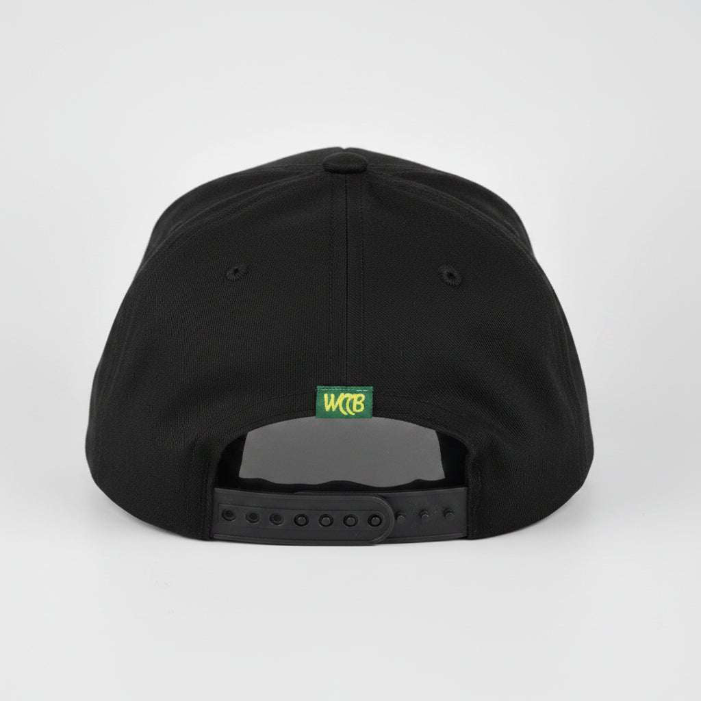 A Black snapback cap shown from the back, featuring a small green and yellow 'WCCB' logo patch and a dark gray plastic adjustment slider, set against a light gray studio background.