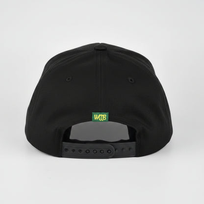 A Black snapback cap shown from the back, featuring a small green and yellow 'WCCB' logo patch and a dark gray plastic adjustment slider, set against a light gray studio background.