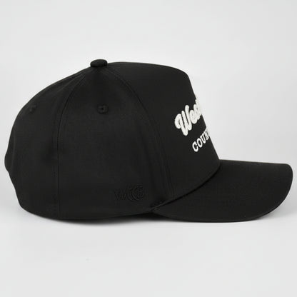 A black baseball cap with WCCB embroidered text on the side, photographed on a light gray studio background.