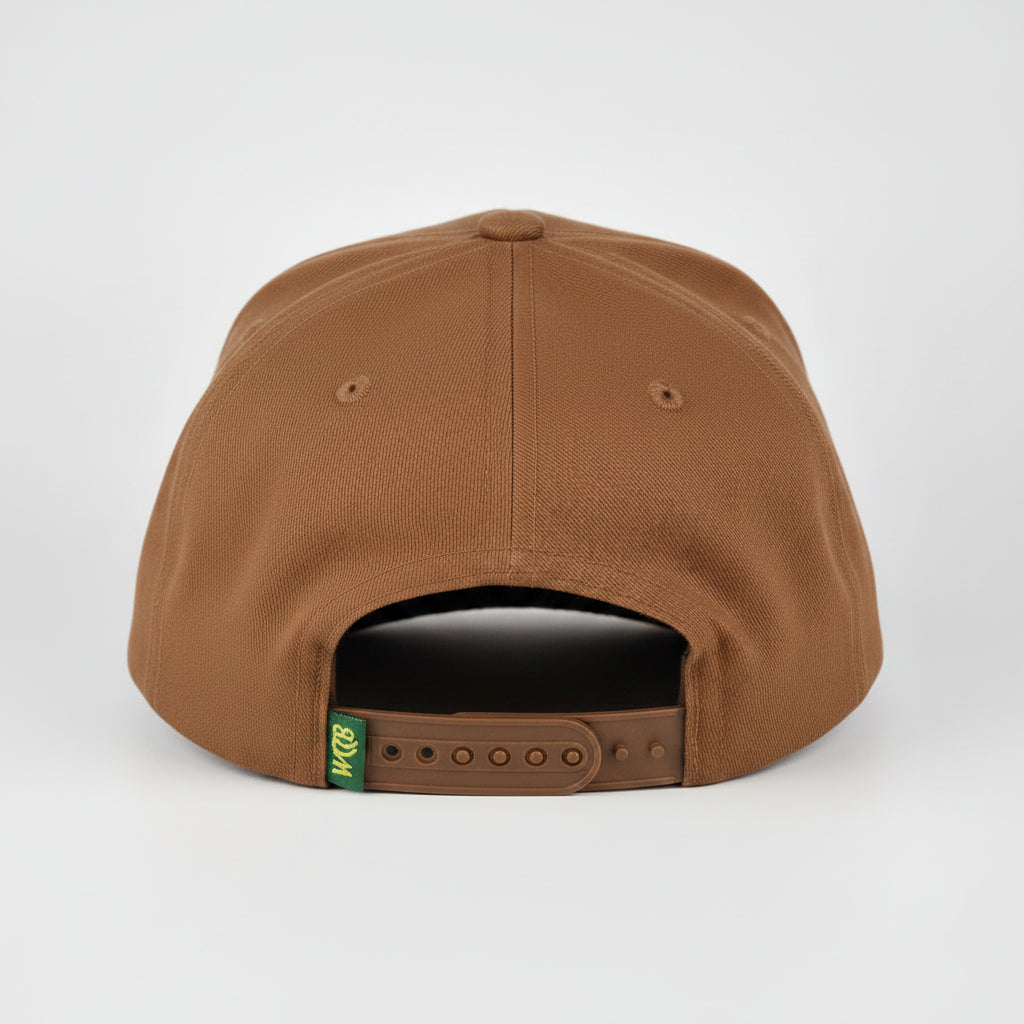 A brown snapback cap shown from the back, featuring a small green and yellow 'WCCB' logo patch and a dark gray plastic adjustment slider, set against a light gray studio background.