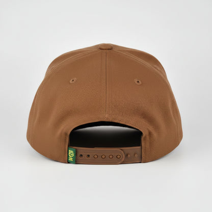 A brown snapback cap shown from the back, featuring a small green and yellow 'WCCB' logo patch and a dark gray plastic adjustment slider, set against a light gray studio background.