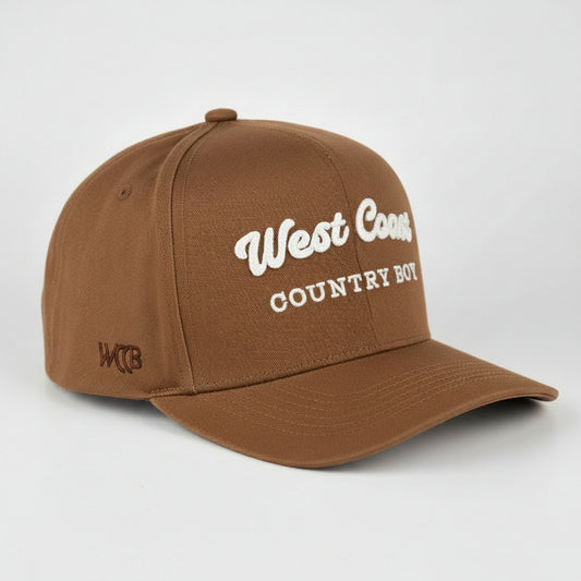 A royal blue baseball cap with 'West Coast COUNTRY BOY' embroidered in white on the front, shown on a light gray studio background.